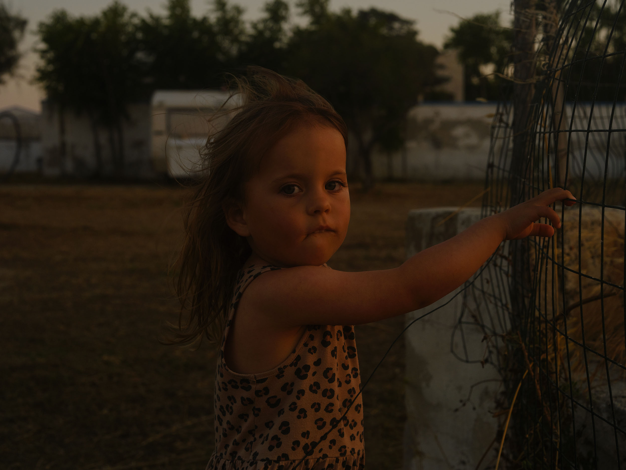 portrait of girl holding fence
